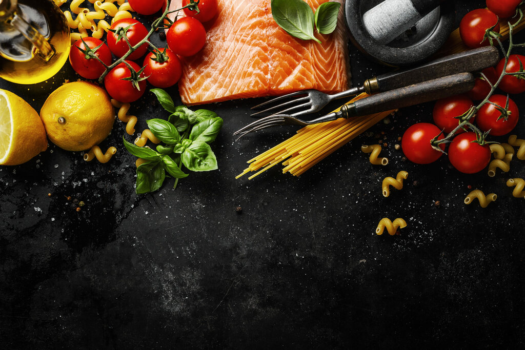 Raw salmon with ingredients for cooking served on table. View from above. Food background.